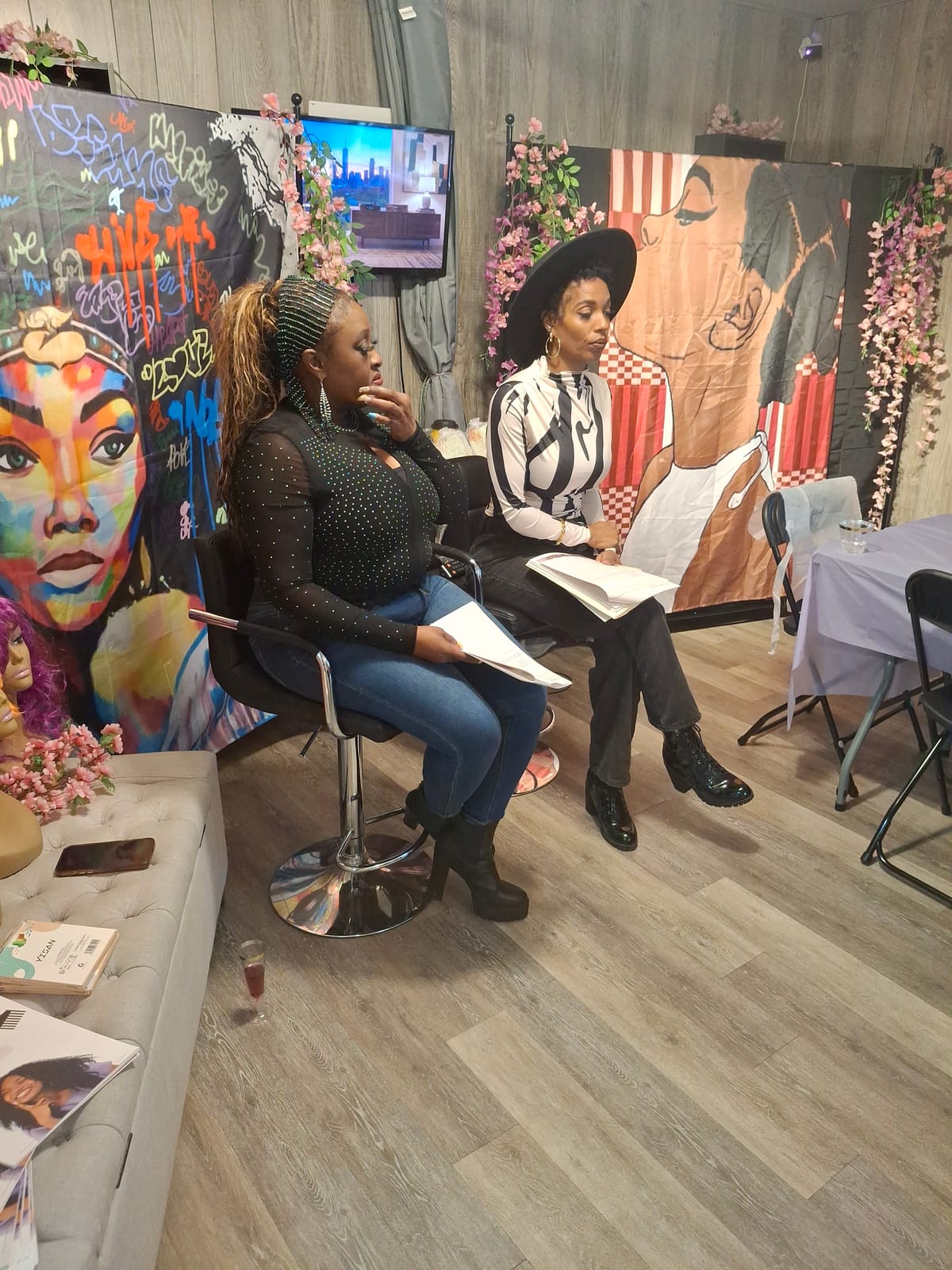 Two guests seated in the salon chairs following along with the hair and scalp shop talk